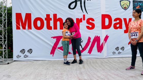 Mother hugging child after run